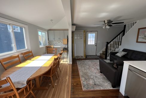 a living room and dining room with hardwood floors.