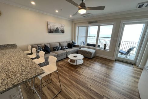 a living room filled with furniture and a large window.