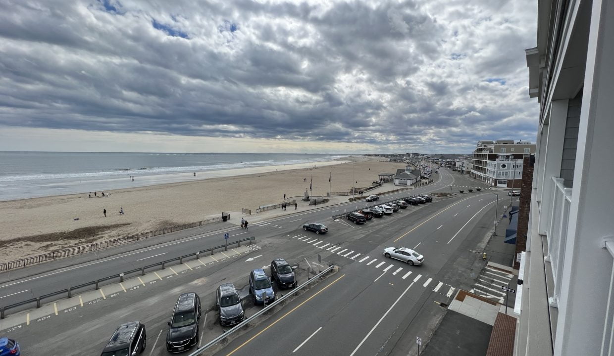 a view of a beach from a balcony of a building.