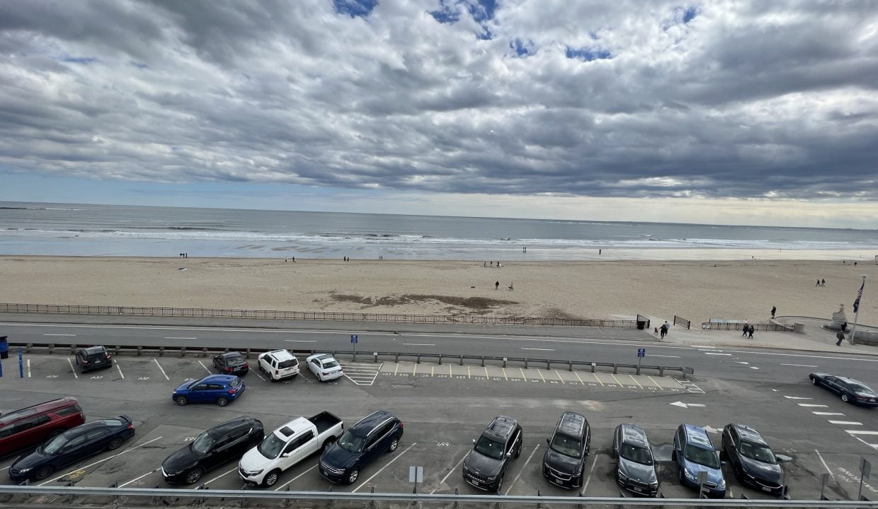 a parking lot filled with lots of parked cars.