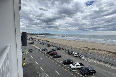 a view of a beach from a balcony of a building.