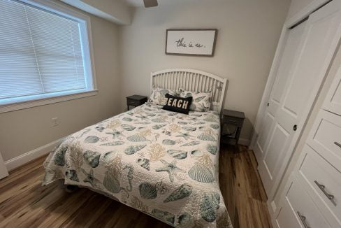 a bed sitting in a bedroom next to a window.