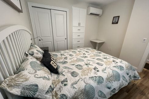 a bedroom with a bed and a ceiling fan.