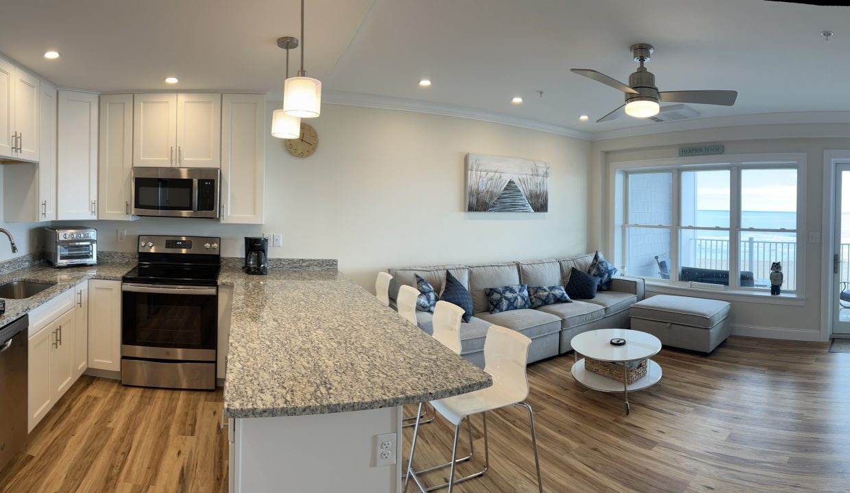 a kitchen and living room with a large window.