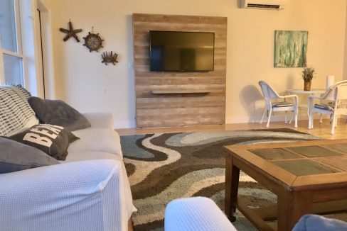 a living room filled with furniture and a flat screen tv.