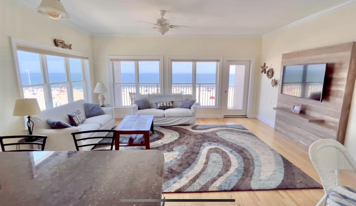 A living room with a view of the ocean.