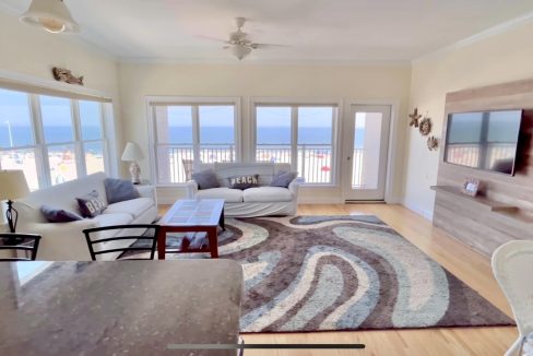 A living room with a view of the ocean.