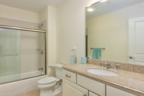 A bathroom with a sink, toilet and shower.