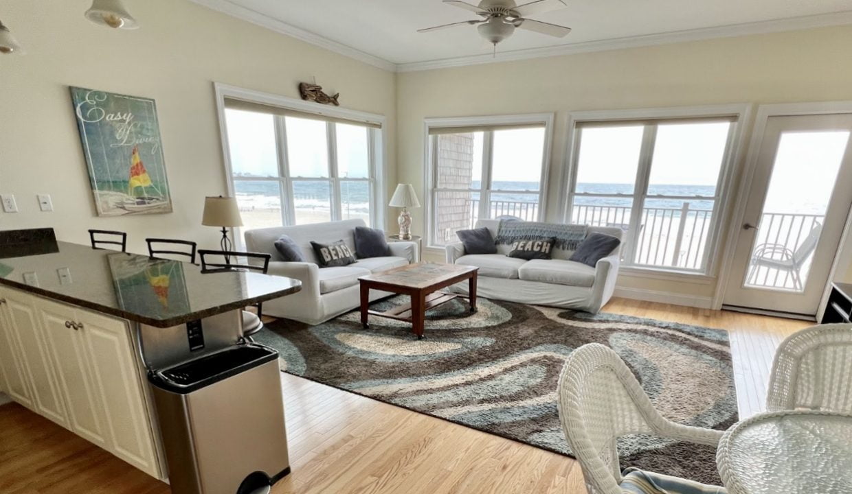 a living room filled with furniture and a large window.