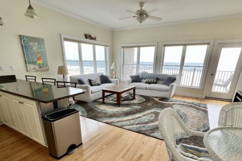 a living room filled with furniture and a large window.