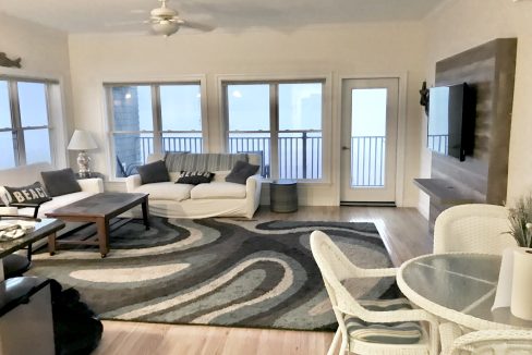 a living room filled with furniture and a flat screen tv.