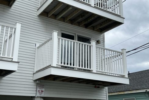 a white house with a white balcony and balconies.