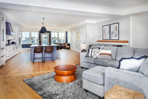 a living room filled with furniture and a kitchen.