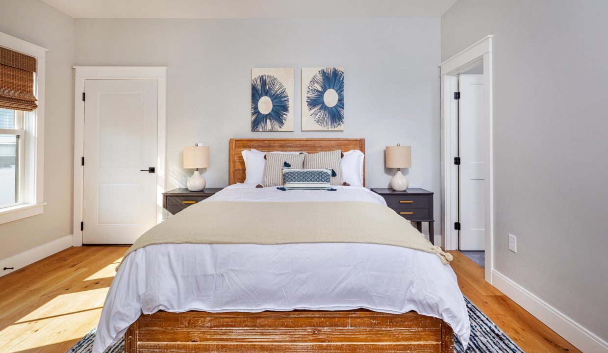 a bed sitting in a bedroom next to a window.