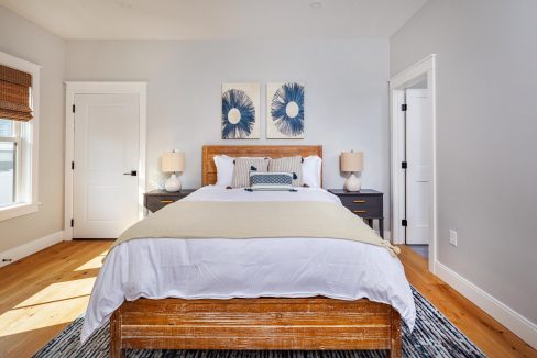 a bed sitting in a bedroom next to a window.