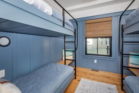 a bedroom with bunk beds and blue walls.