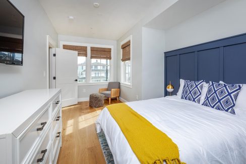 a bedroom with a large bed and a flat screen tv.