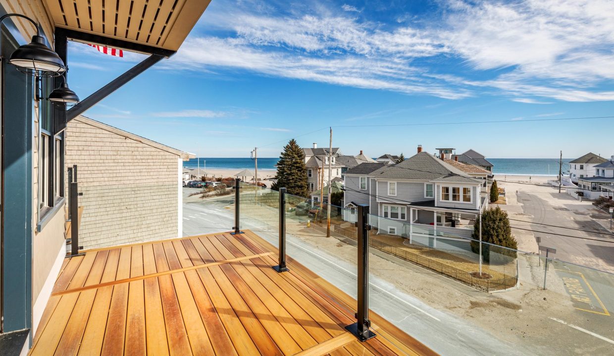 a wooden deck with a view of the ocean.
