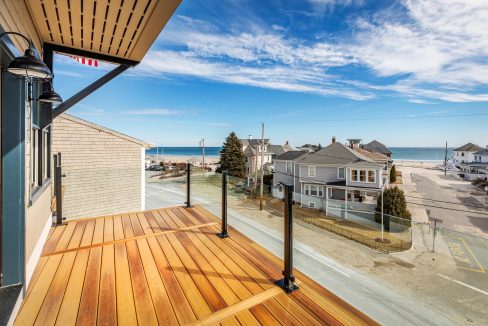 a wooden deck with a view of the ocean.