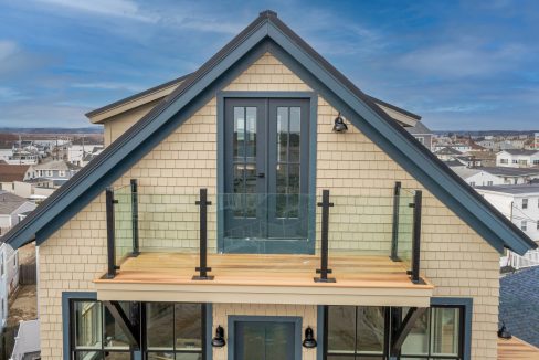 a small house with a deck on top of it.