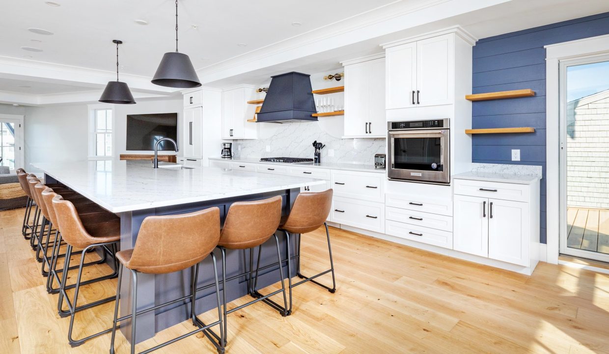 a large kitchen with a center island and bar stools.