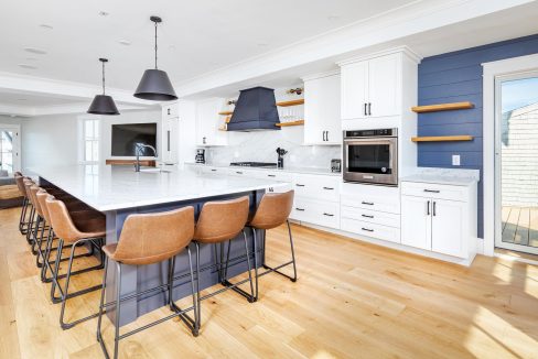 a large kitchen with a center island and bar stools.