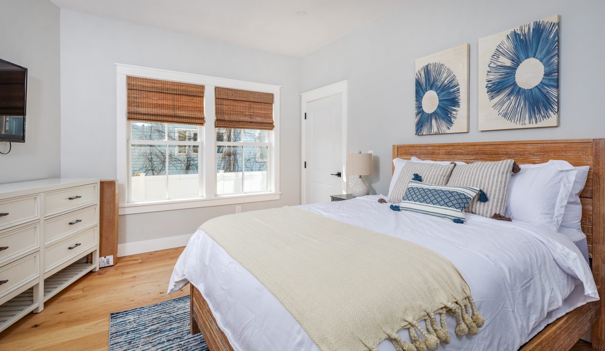 a bedroom with a large bed and a flat screen tv.