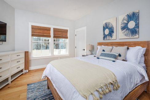 a bedroom with a large bed and a flat screen tv.