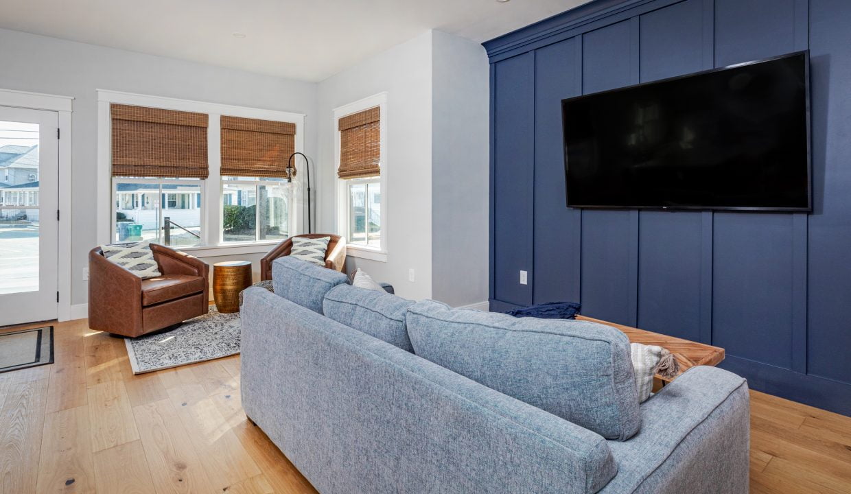 a living room filled with furniture and a flat screen tv.