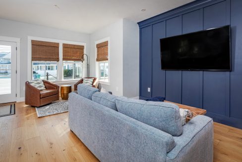 a living room filled with furniture and a flat screen tv.