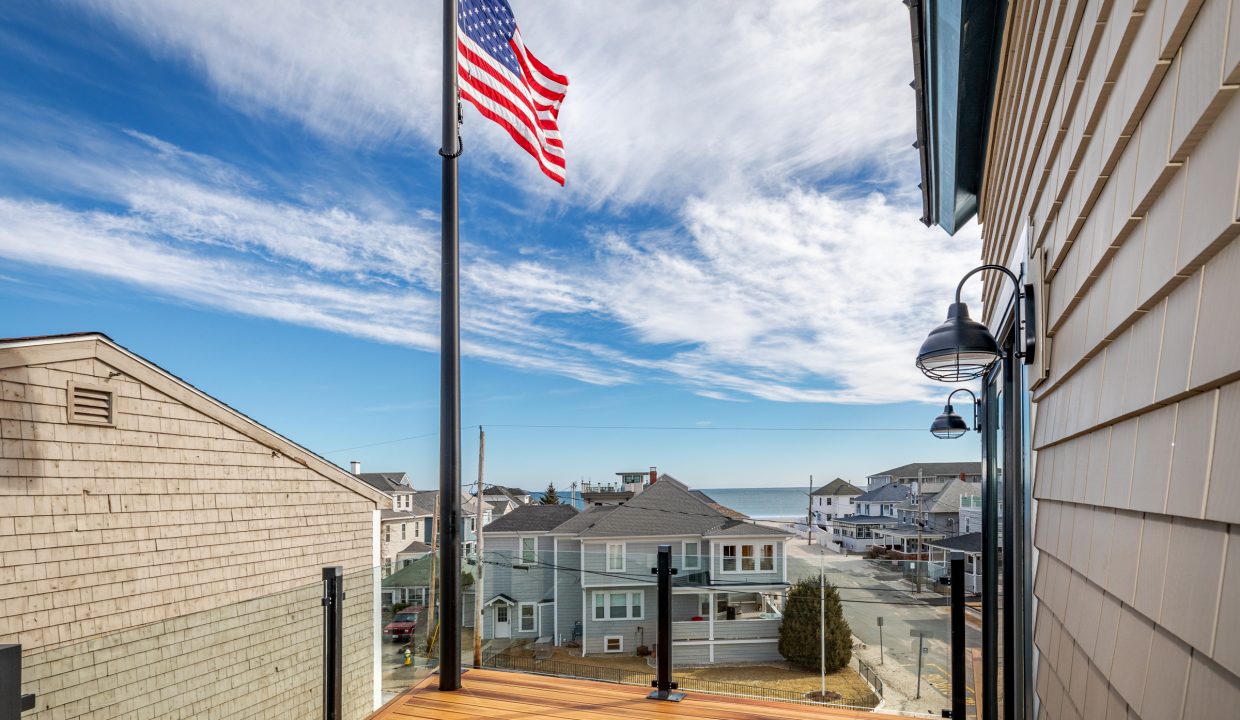 an american flag is flying on a sunny day.