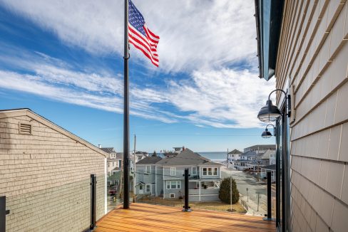 an american flag is flying on a sunny day.