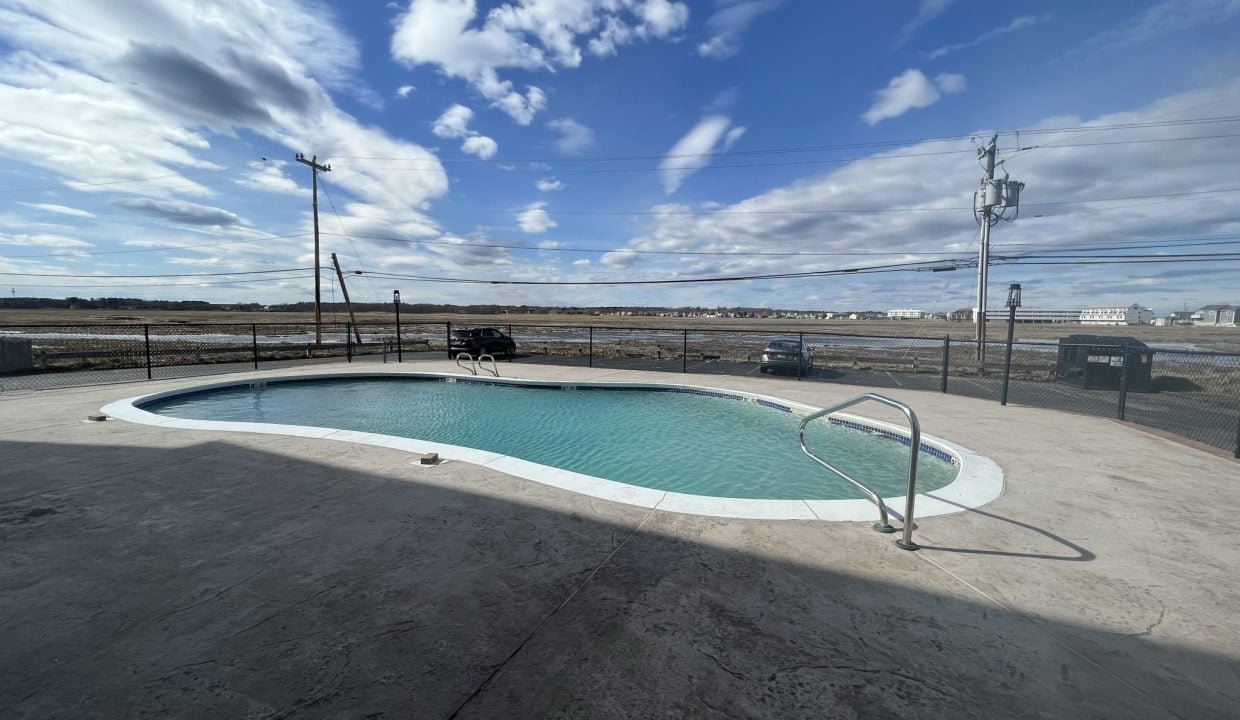 an empty swimming pool in a parking lot.