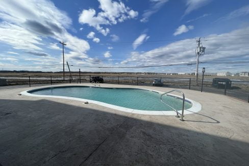 an empty swimming pool in a parking lot.