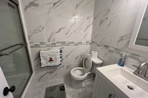 a white toilet sitting next to a white sink.