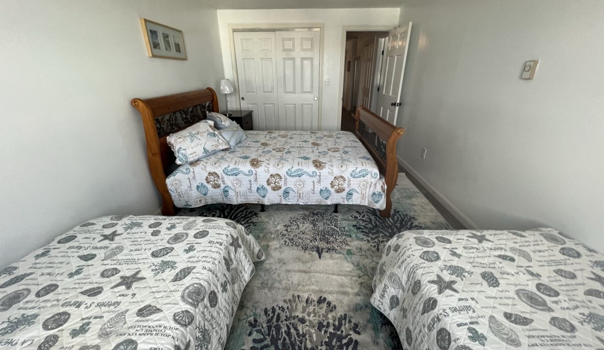 a bed room with two beds and a door.