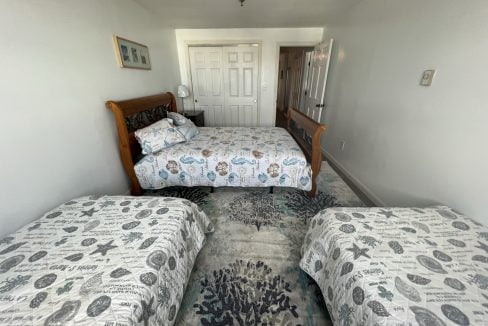 a bed room with two beds and a door.