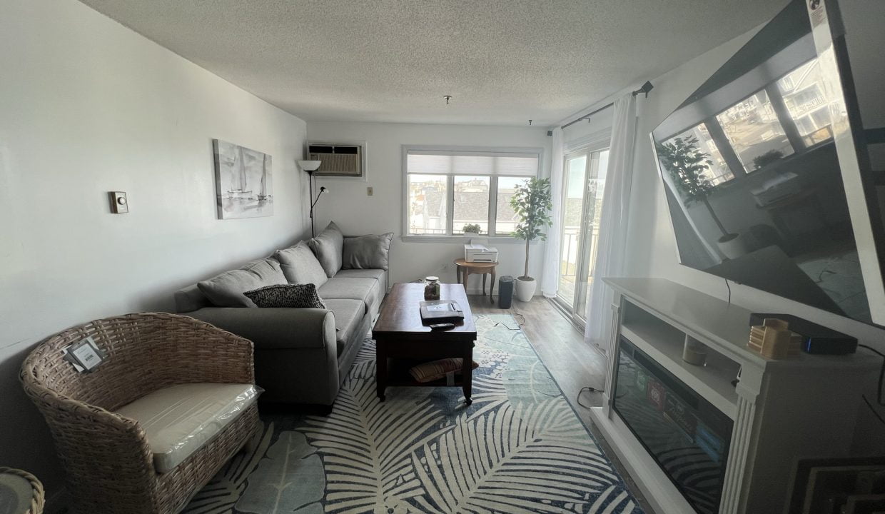 a living room filled with furniture and a flat screen tv.
