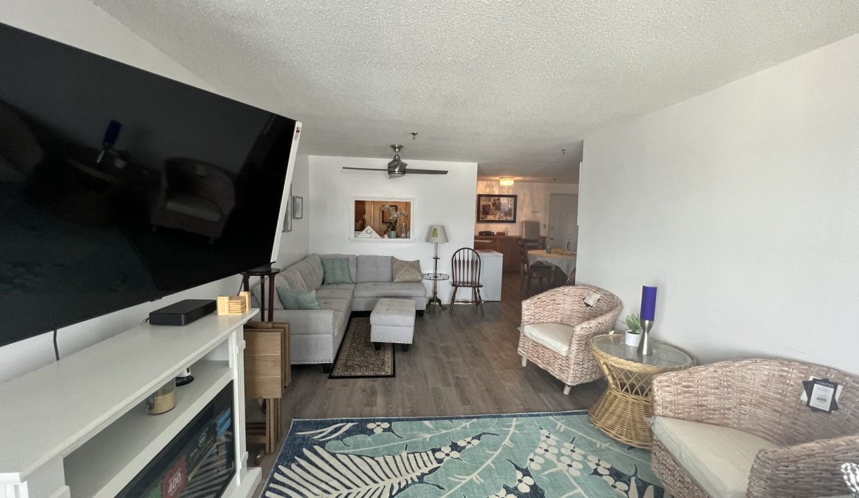 a living room filled with furniture and a flat screen tv.