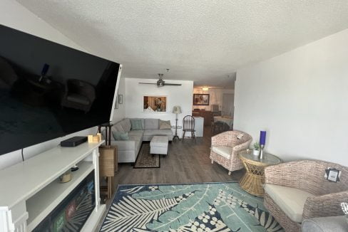 a living room filled with furniture and a flat screen tv.