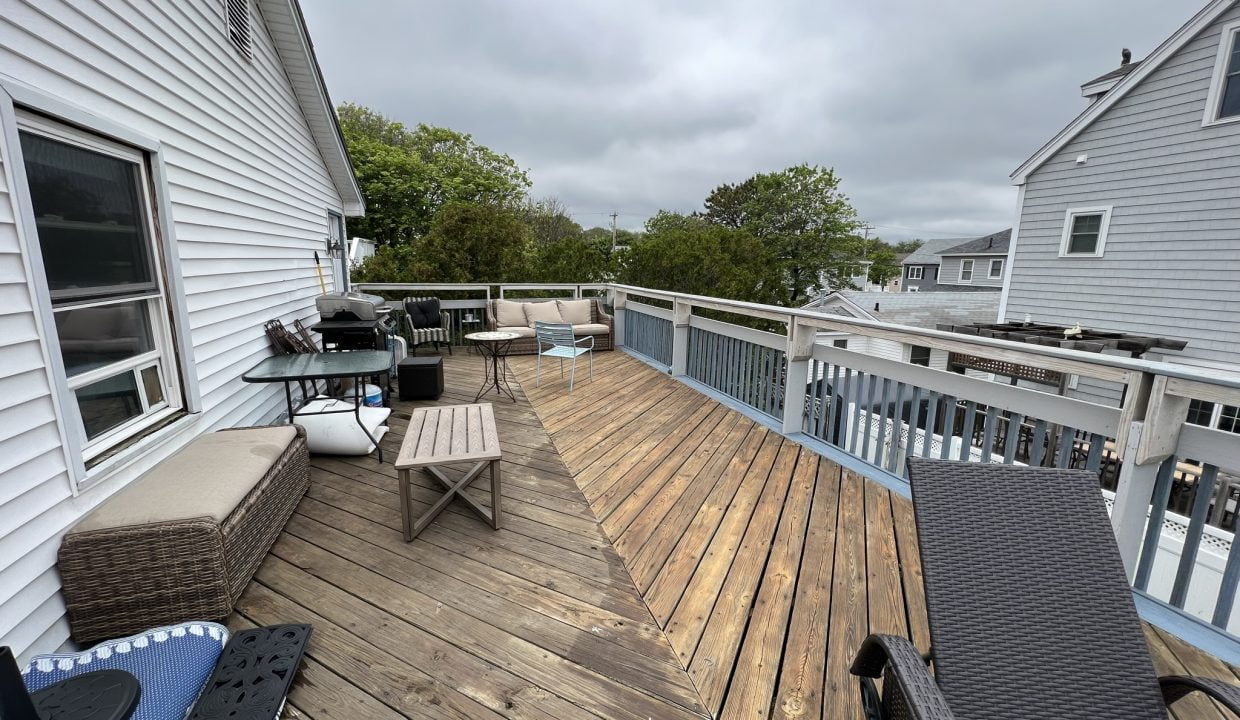 a deck with chairs and a table on it.