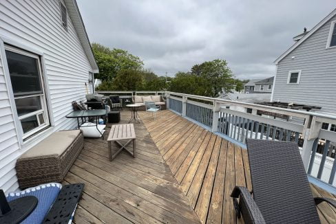 a deck with chairs and a table on it.