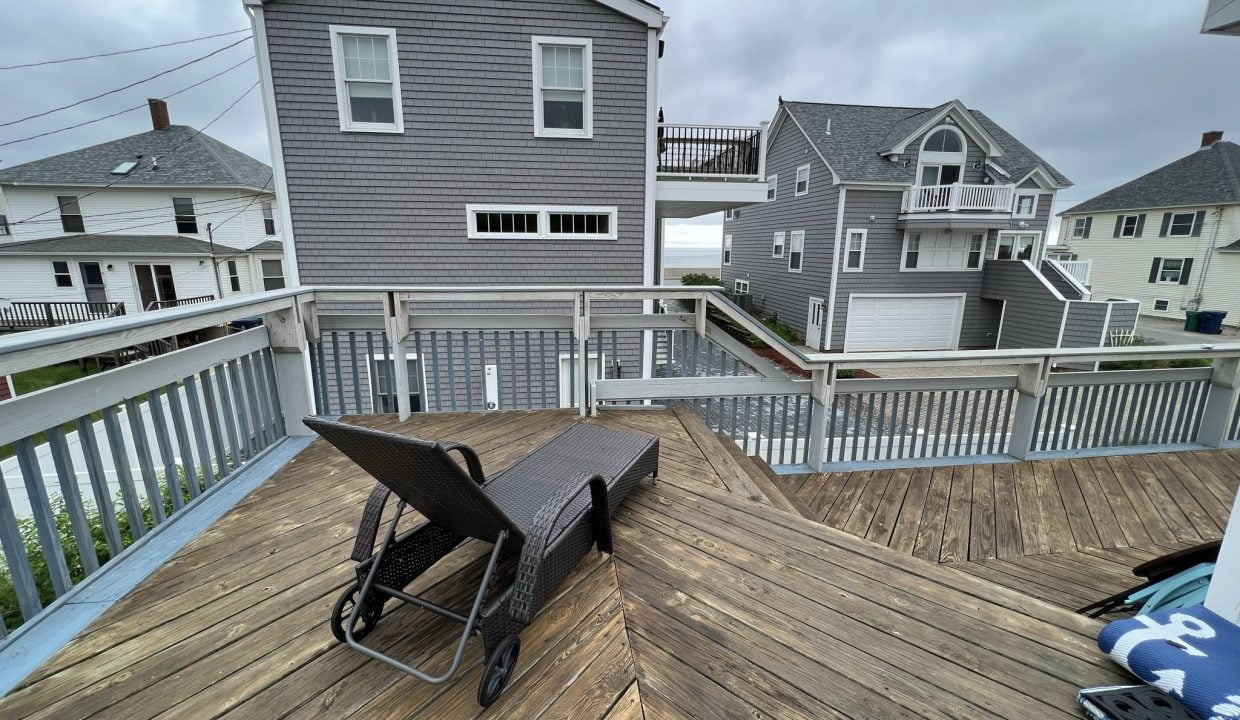 a wooden deck with a picnic table on it.