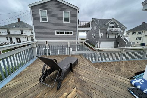 a wooden deck with a picnic table on it.
