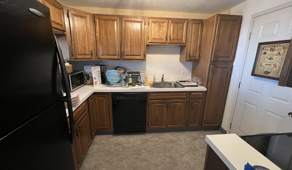a black refrigerator freezer sitting inside of a kitchen.