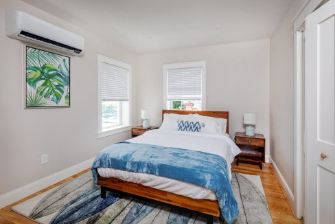 a bed sitting in a bedroom next to a window.