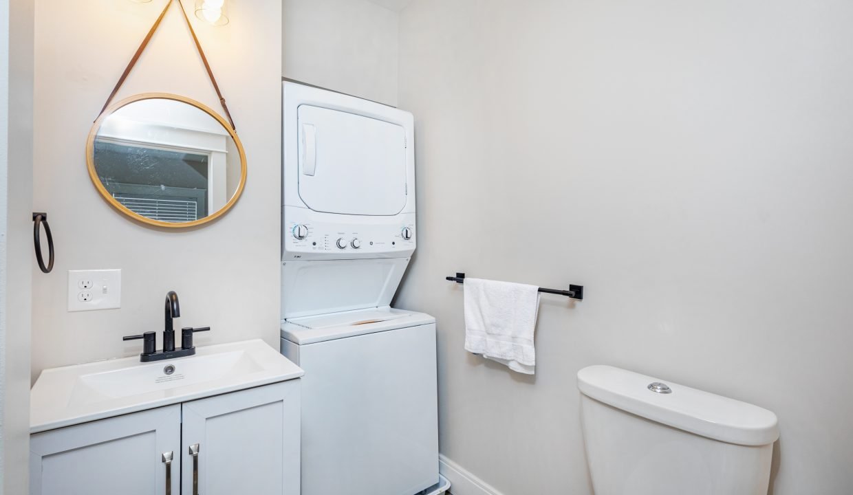 a bathroom with a washer and dryer in it.