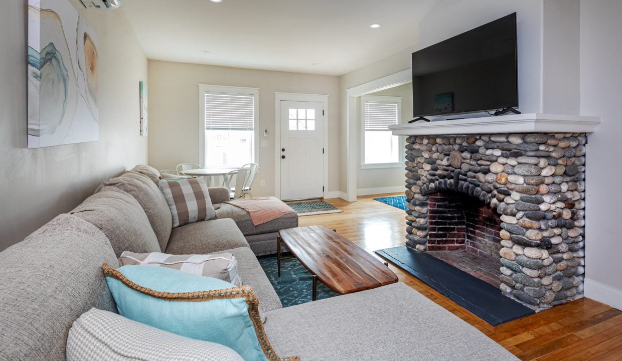 a living room with a fire place and a couch.