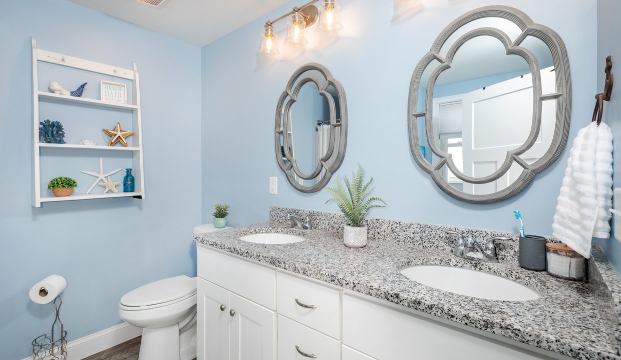 a bathroom with two sinks and a toilet.