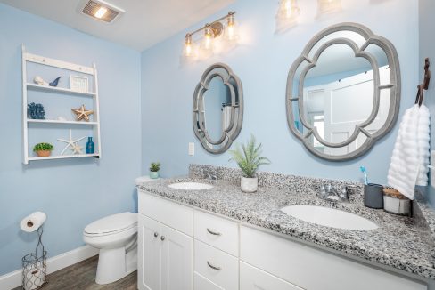 a bathroom with two sinks and a toilet.